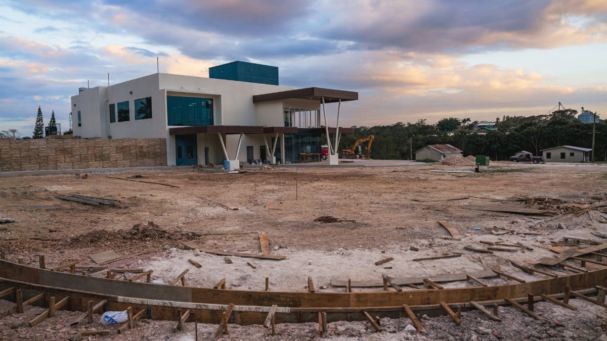 Contemporary building construction site in Spanish Lookout, Belize, during a cloudy day.