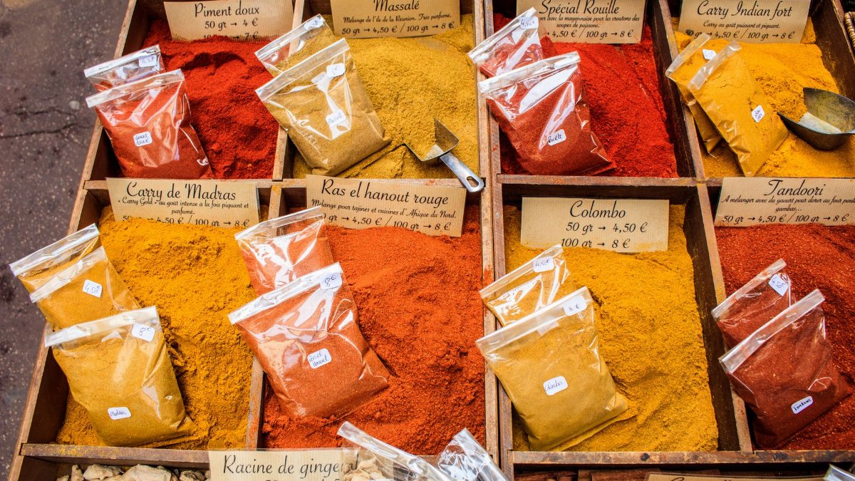 Vibrant spices displayed at a local market in Nice, France, showcasing diverse colors and flavors.