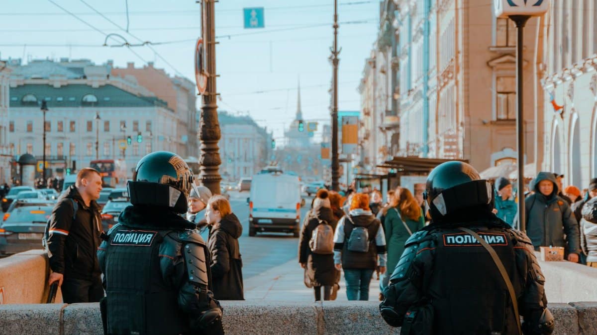 Uniformed police officers manage a busy street crowd in Saint Petersburg, Russia.