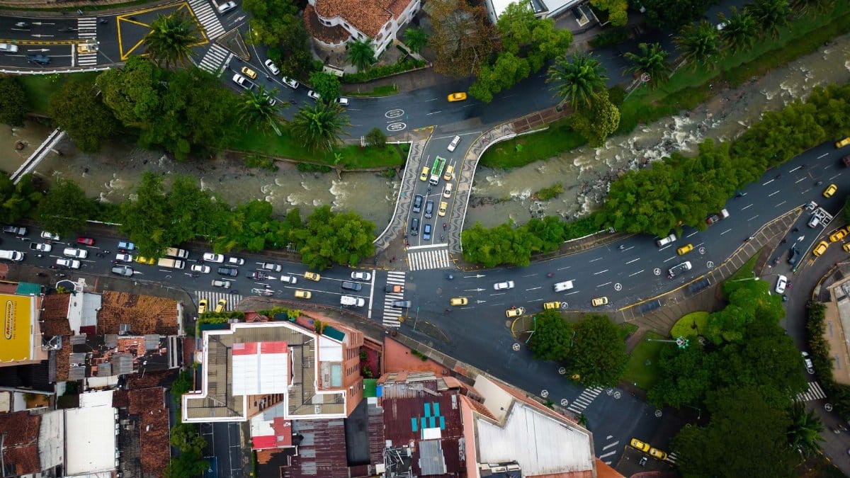 Top-down view of urban roads, river, and traffic in a cityscape.
