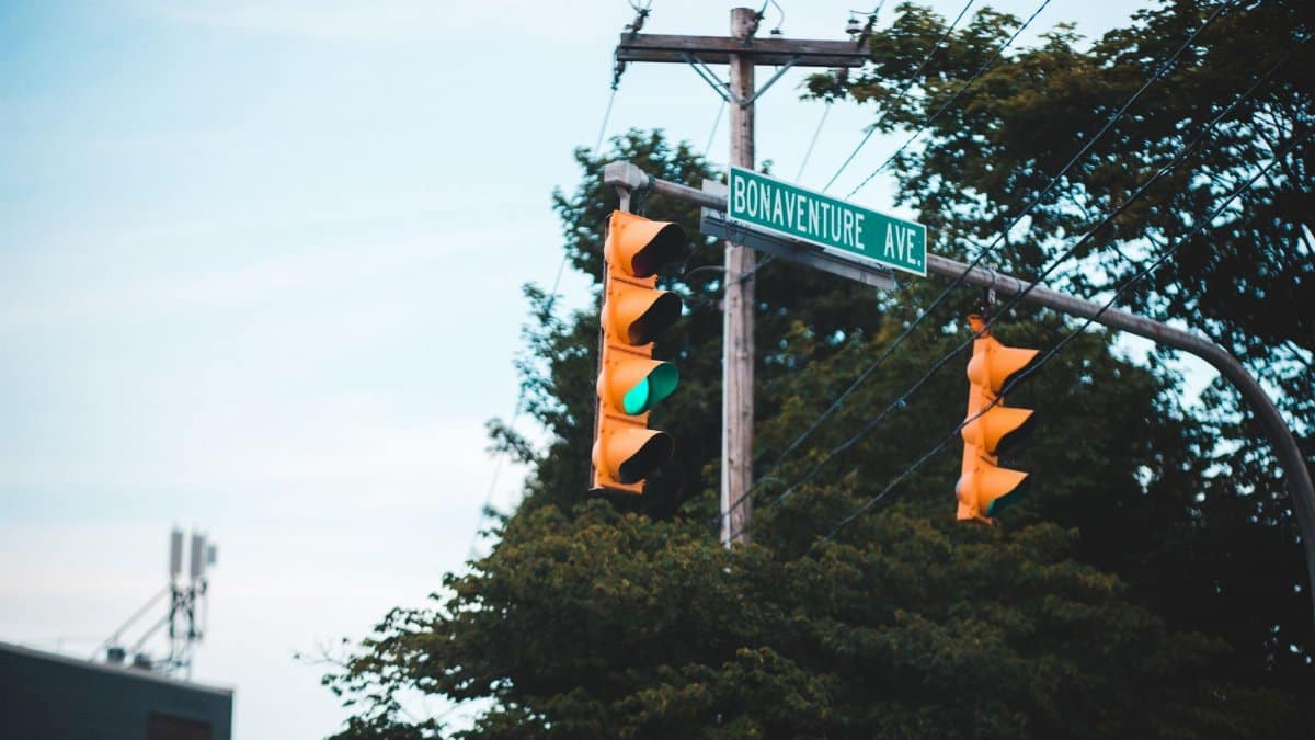 Close-up of a green traffic light at an intersection with street signs on Bonaventure Ave.