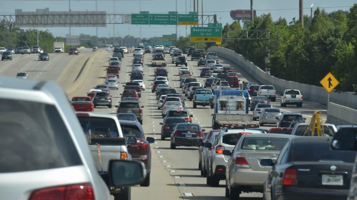 Dense traffic on an urban expressway during the day, showcasing congestion and vehicles.