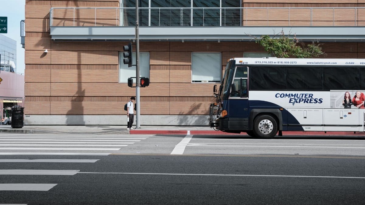 A city commuter express bus parked at an intersection, capturing urban life.