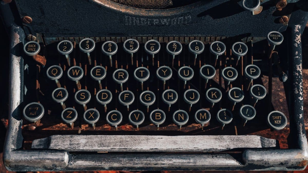 Close-up of vintage typewriter keys with retro aesthetic and detailed buttons. Ideal for nostalgic themes.