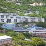 Aerial view showcasing buildings nestled in lush greenery, capturing urban life amidst nature.