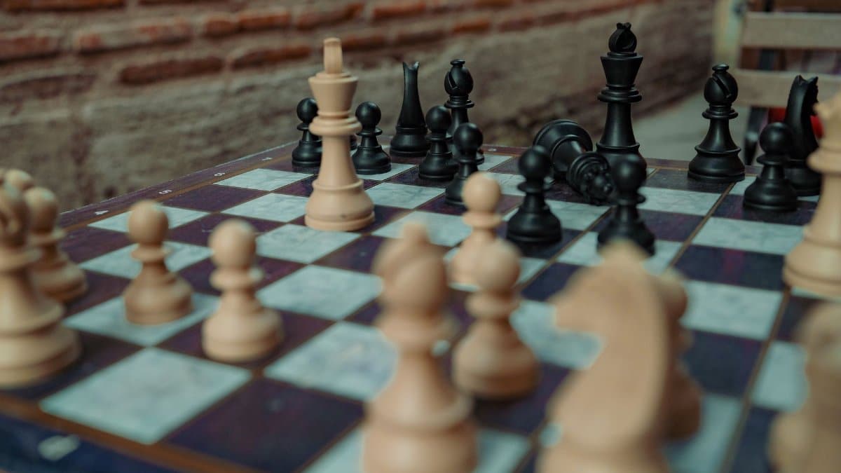 Close-up of a chessboard with captured pieces in a strategic game setting.