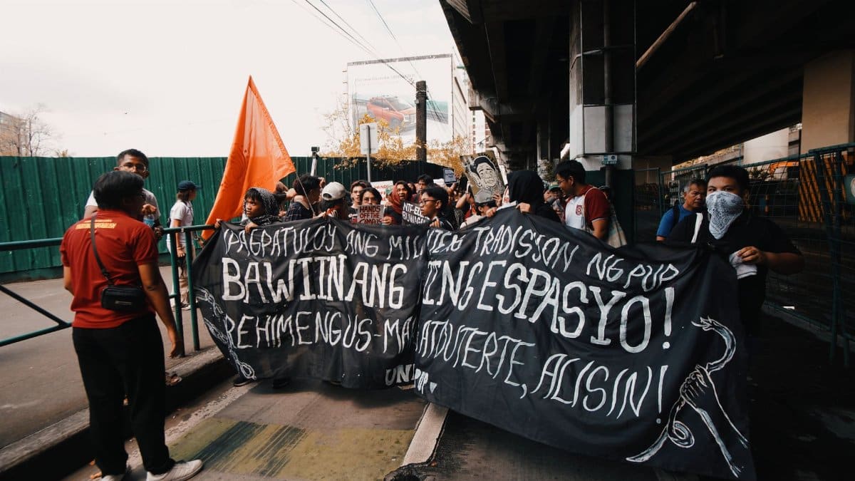 A group of protesters with masks and banner demanding change. Urban protest scene.