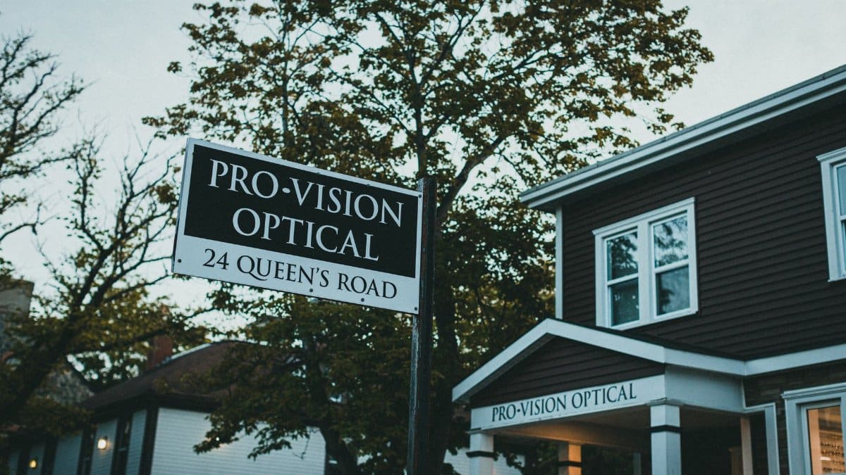 Street view of Pro-Vision Optical signage and storefront, showcasing local business atmosphere.
