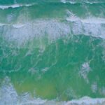 A stunning aerial shot of ocean waves crashing on the beach in Florida.