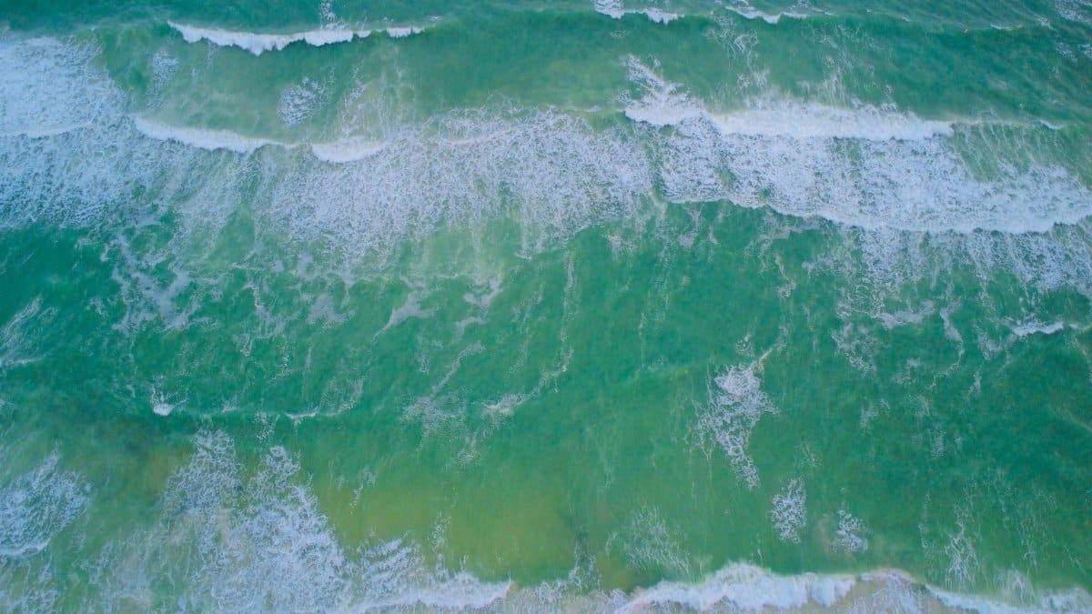 A stunning aerial shot of ocean waves crashing on the beach in Florida.