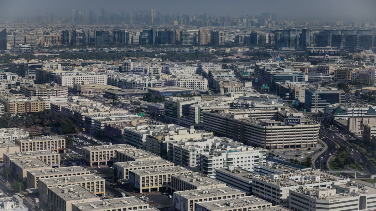 Aerial view showcasing the dense urban architecture of Dubai, featuring modern buildings and city life.