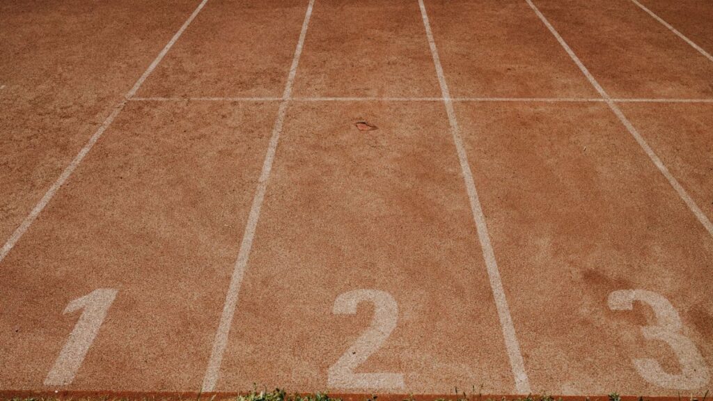 Outdoor sports track with lanes numbered 1 to 3, ready for an athletic event.