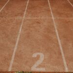 Outdoor sports track with lanes numbered 1 to 3, ready for an athletic event.