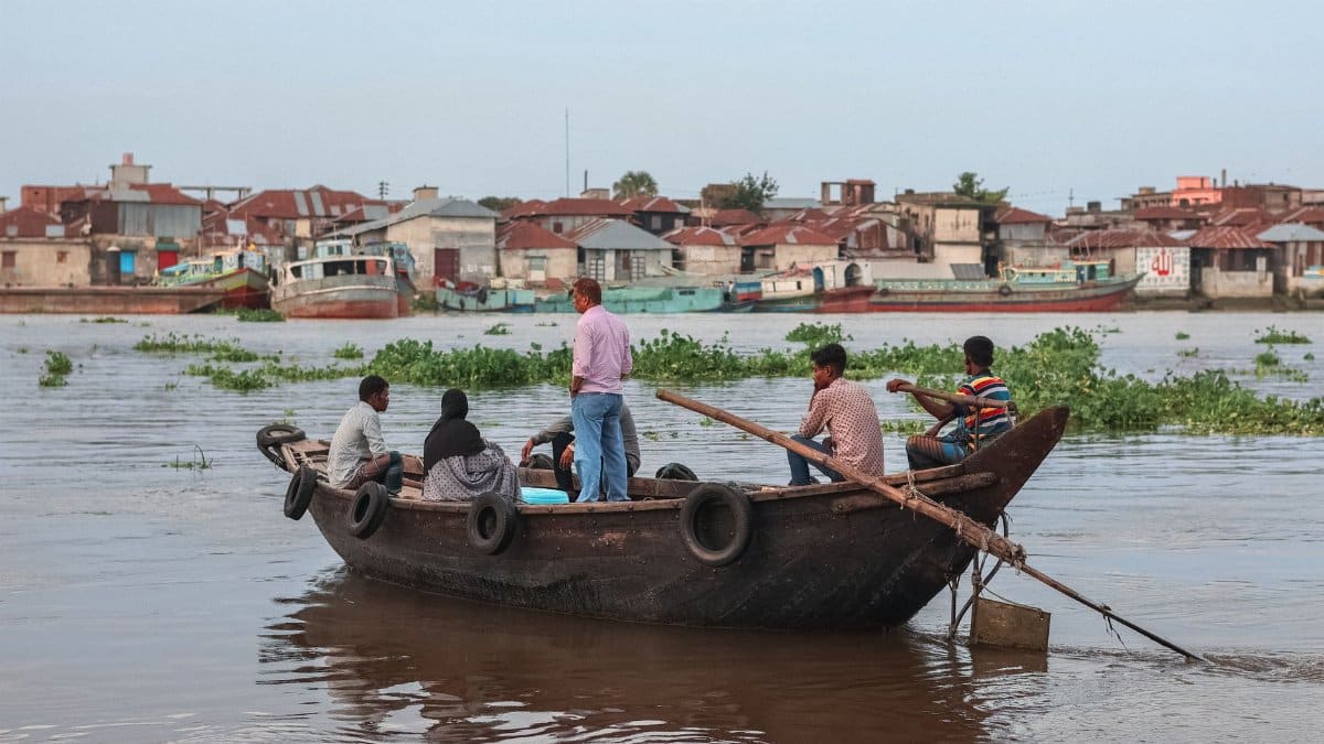 A group of people on a traditional fishing boat in Chandpur, Bangladesh, showcasing rural life.