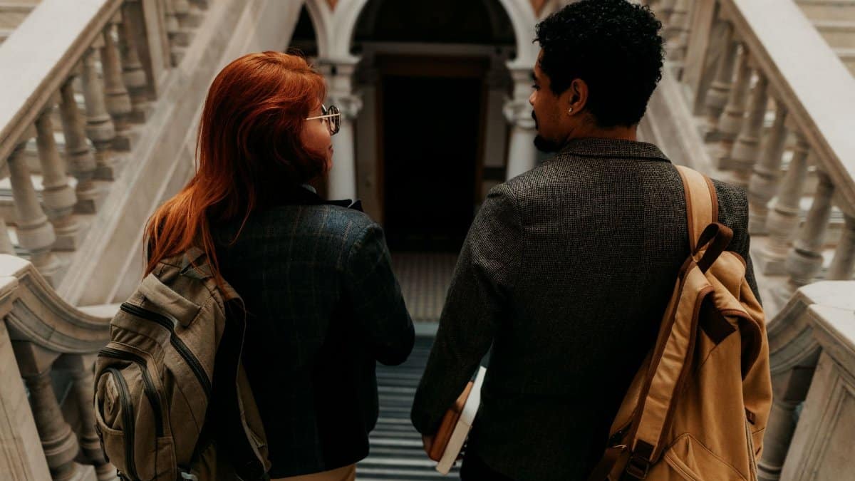 Two students walking down a historic staircase in Buenos Aires, Argentina.