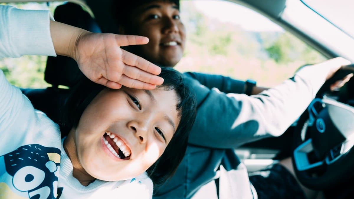 A cheerful father and child enjoying a fun-filled road trip together.