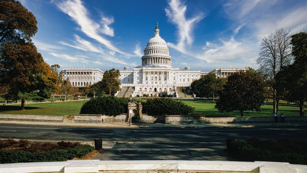Panoramic view of the United States Capitol in Washington, D.C. under a clear blue sky.
