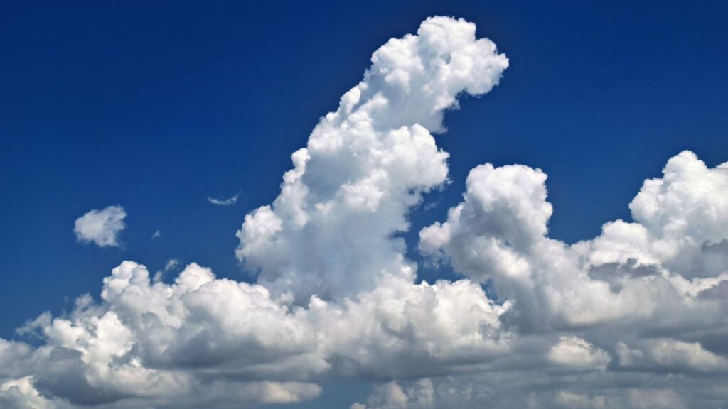 Stunning cumulus clouds in a vibrant blue sky over Sarasota, Florida.