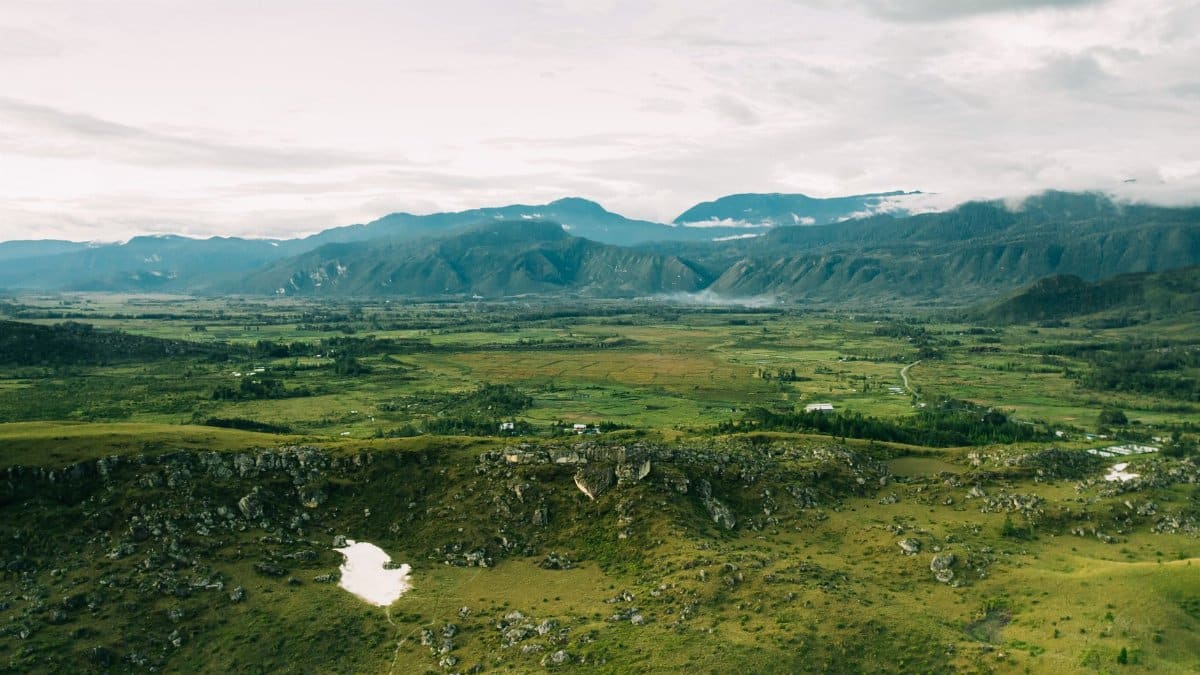 Explore the stunning aerial view of Papua Pegunungan's vast, green valleys and mountains in Indonesia.