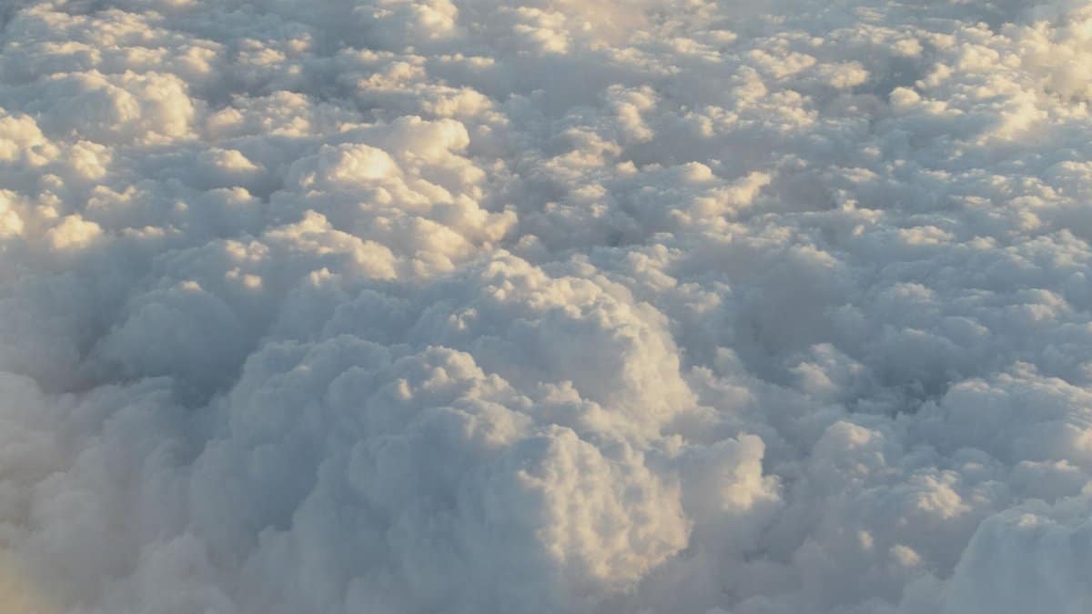 A serene aerial view of fluffy stratocumulus clouds, capturing the soft textures and patterns from high altitude.