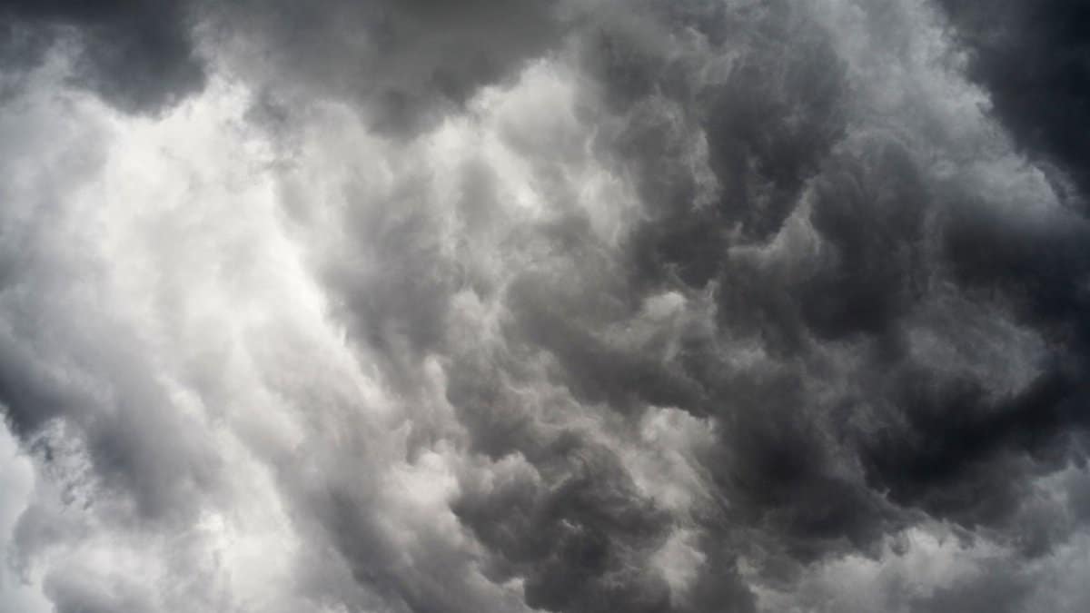 A striking monochrome image of dramatic dark clouds forming a moody sky.