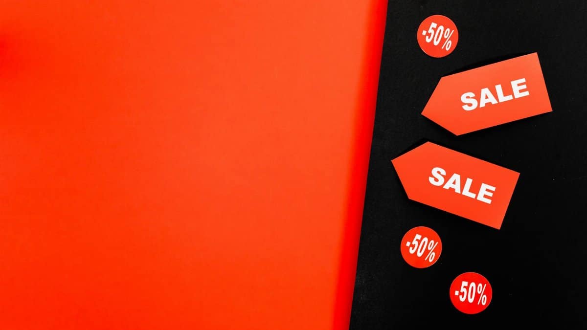 Dynamic red and black background featuring sale tags and 50% discount signs for promotions.