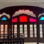 Decorative arched doors with vibrant stained glass in a historic building.