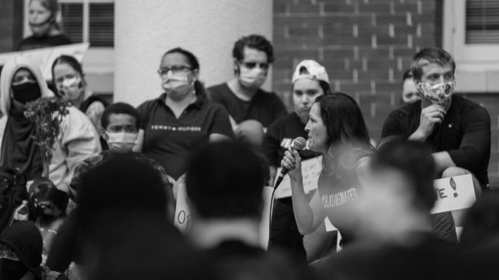 Black and white photo of a peaceful protest with people speaking in Brooksville, Florida.