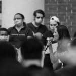 Black and white photo of a peaceful protest with people speaking in Brooksville, Florida.