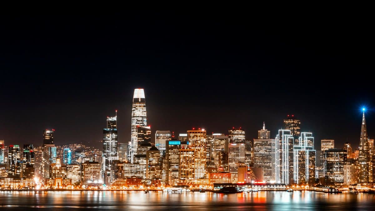 Breathtaking view of the illuminated San Francisco skyline reflecting on the water at night.