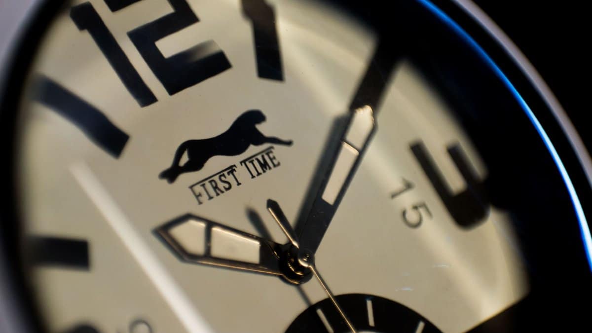 A detailed close-up of a wristwatch dial with focus on time and precision.