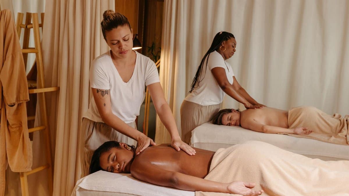 Women receiving soothing massages in a cozy spa for relaxation and stress relief.