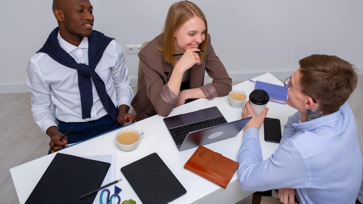 A diverse group of professionals collaborating at a modern workspace, fostering teamwork and creativity.