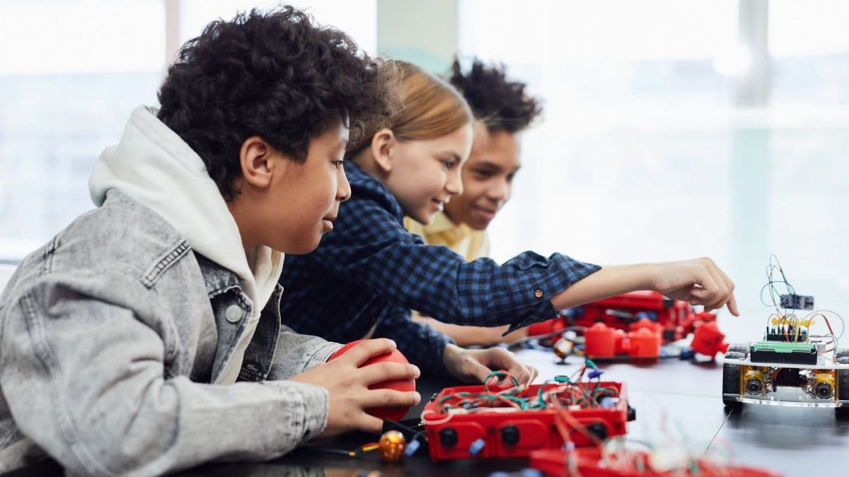 Children working on a robotics project in a classroom setting, exploring technology and creativity.