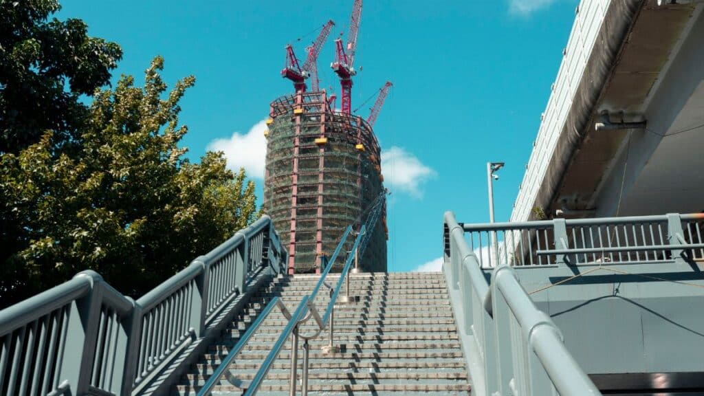 Modern construction site with cranes towering above a city staircase in Taipei, Taiwan.
