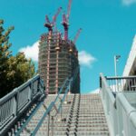 Modern construction site with cranes towering above a city staircase in Taipei, Taiwan.