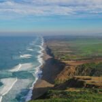 Breathtaking aerial view of Point Reyes National Seashore with sweeping coastline and lush landscapes.