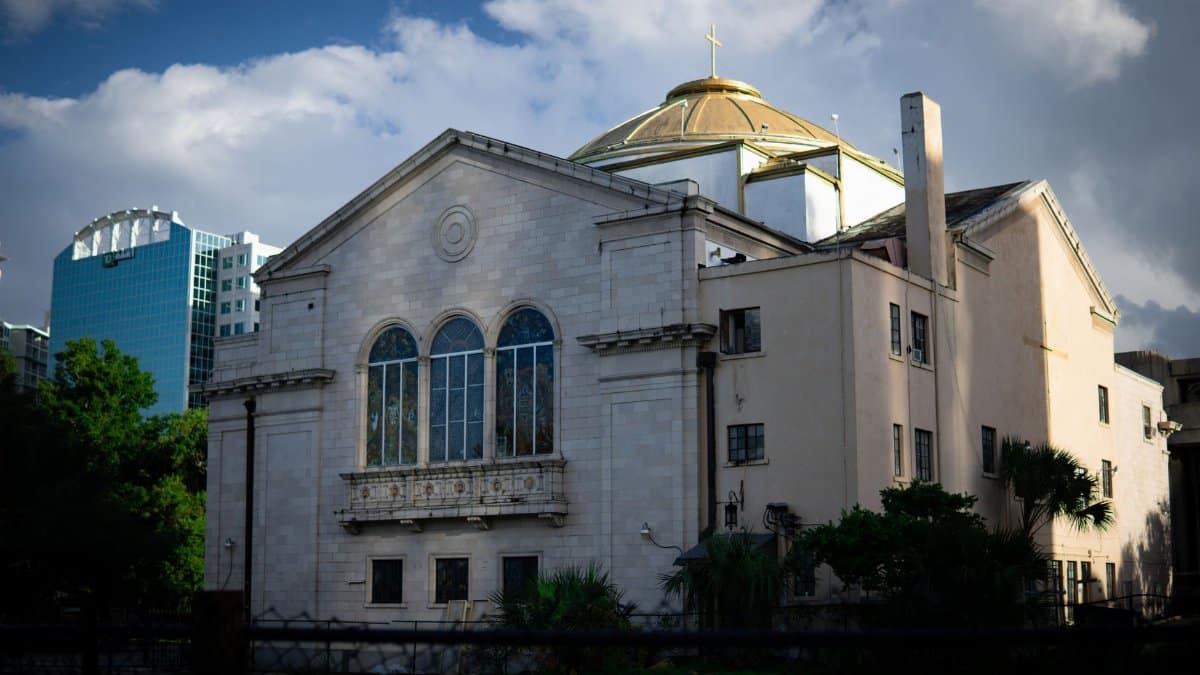 A beautiful historic church in Orlando, Florida, with a vibrant city backdrop.
