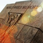 A striking view of a World War II memorial with lens flare enhancing its historic significance.