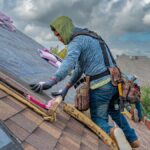 Roofers working on shingle installation on a home in Fort Worth, Texas under blue skies.
