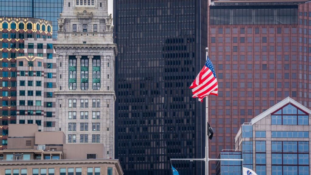 View of Boston's skyline featuring the iconic Custom House and American flag.