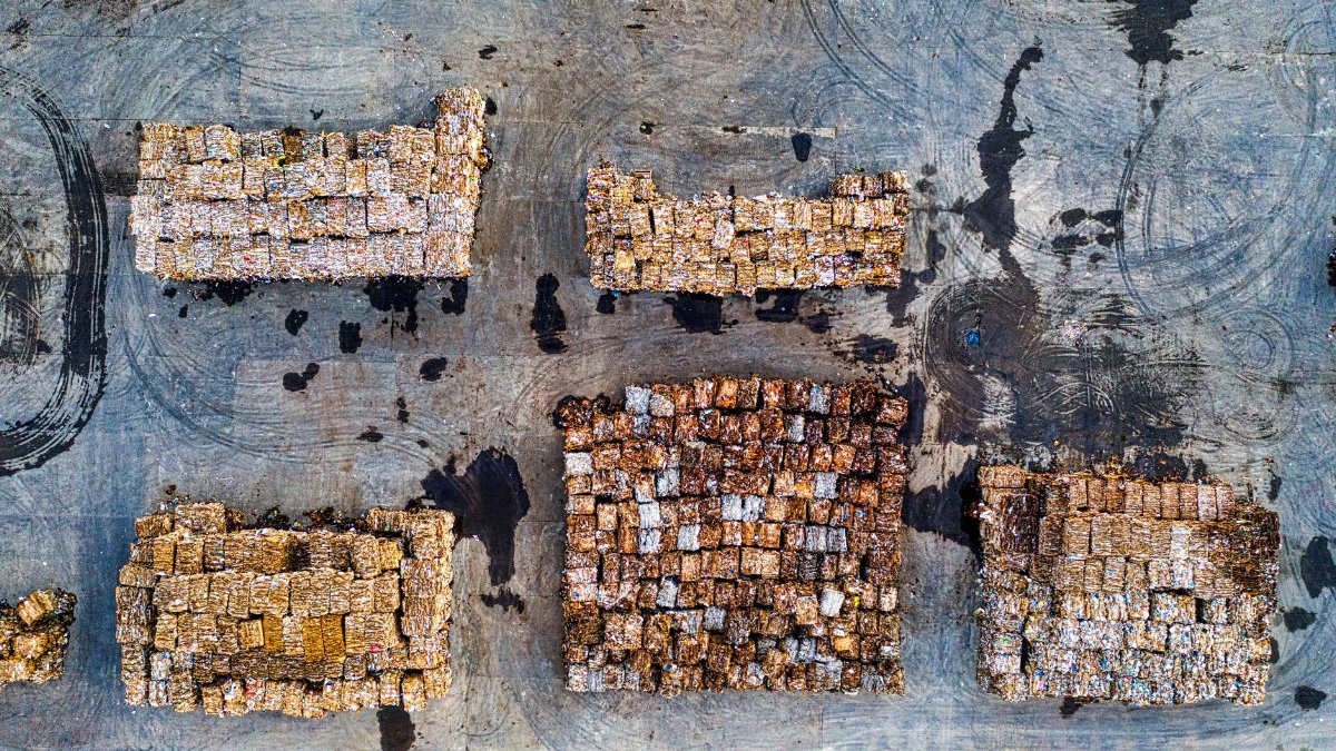 Aerial shot of organized recyclable material stacks in Serang, Indonesia, highlighting waste management efforts.