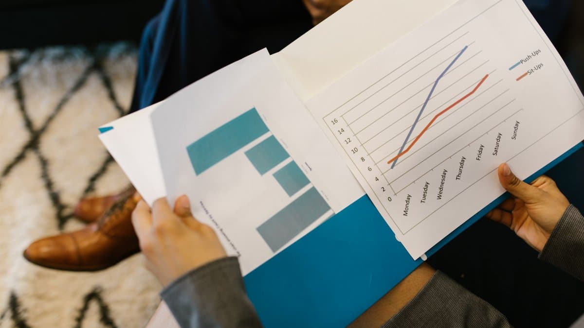 Detailed view of business reports with graphs during a corporate meeting.
