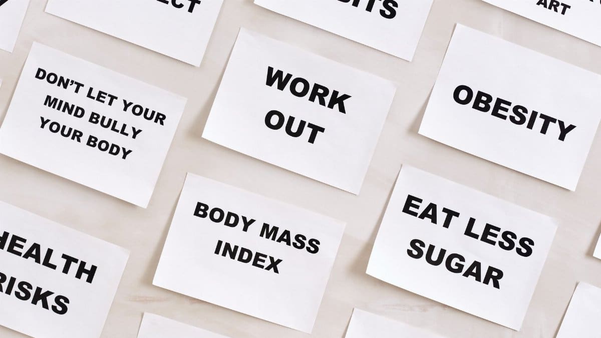 Flat lay of motivational health quotes on paper, promoting healthy habits and self-care.
