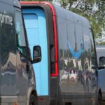 Amazon Prime delivery vans lined up for logistics operations in an urban setting.