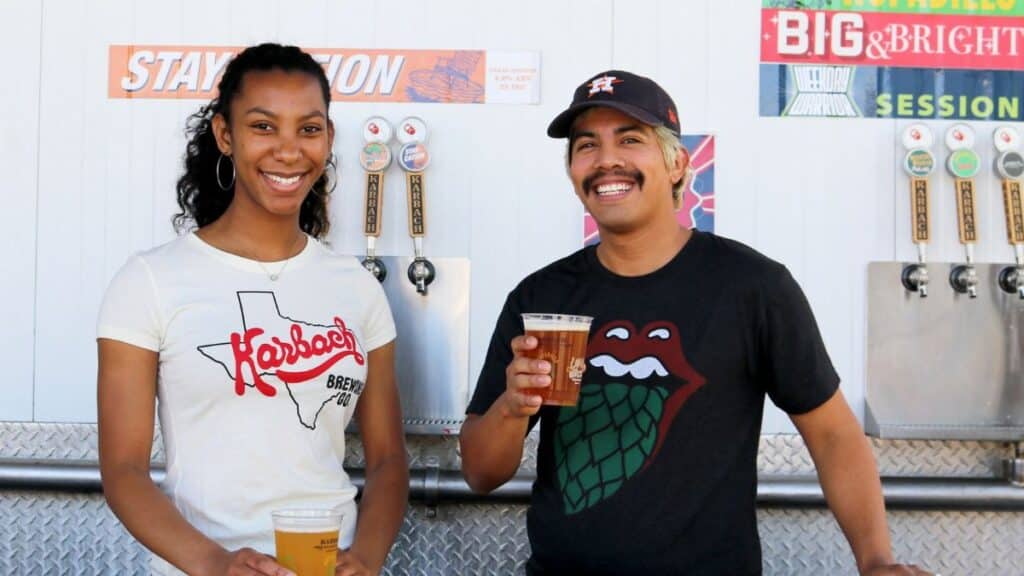 Two friends enjoying craft beer at a brewery, smiles and casual attire enhance the fun atmosphere.