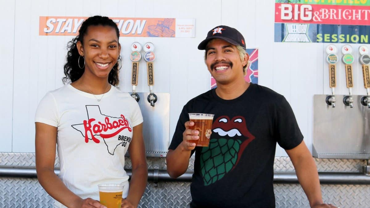 Two friends enjoying craft beer at a brewery, smiles and casual attire enhance the fun atmosphere.