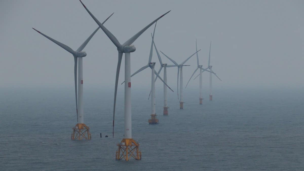 Offshore wind turbines generating clean energy in the ocean breeze.