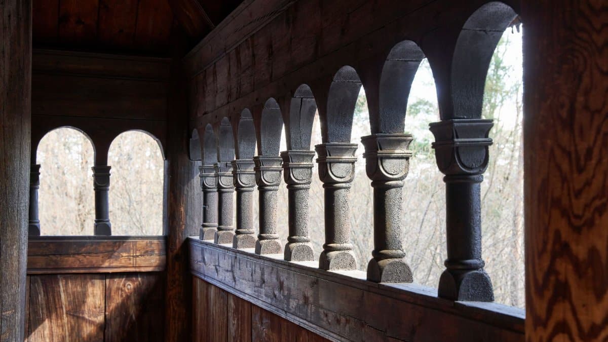 Explore a wooden balustrade highlighting Nordic architectural details in an Oslo church.