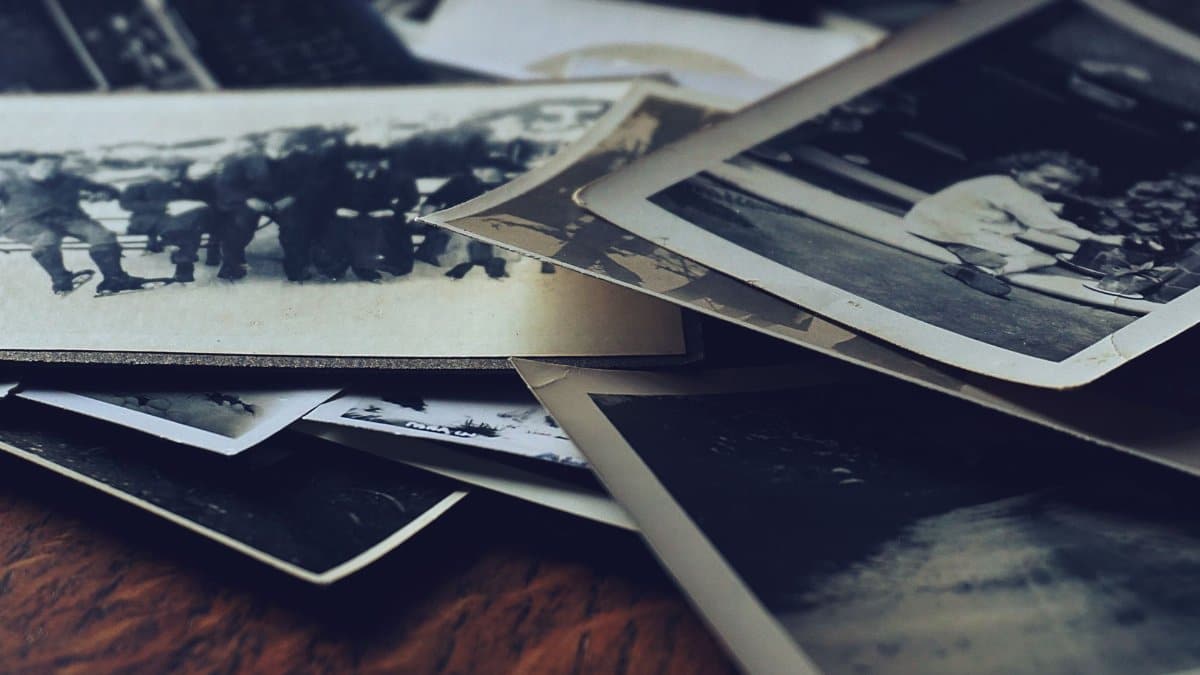 A stack of classic black and white photographs showcasing family memories and history.